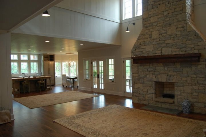 Medium sized classic open plan living room in Huntington with white walls, dark hardwood flooring, a standard fireplace, a stone fireplace surround, a built-in media unit and brown floors.