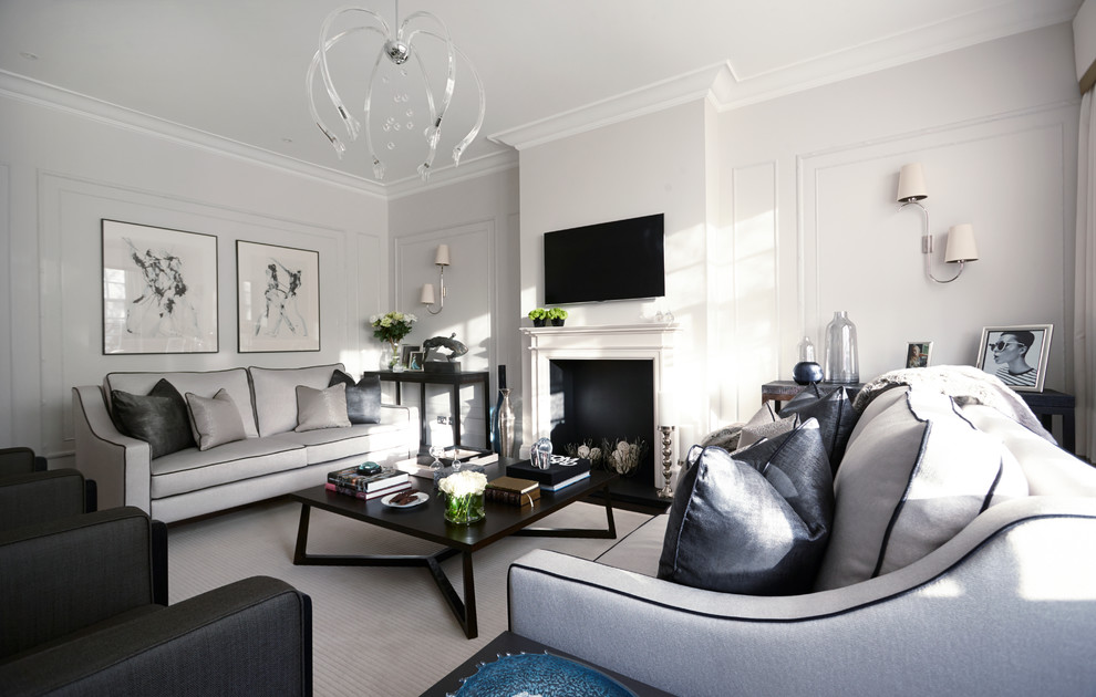 Example of a trendy formal living room design in London with white walls and a wall-mounted tv