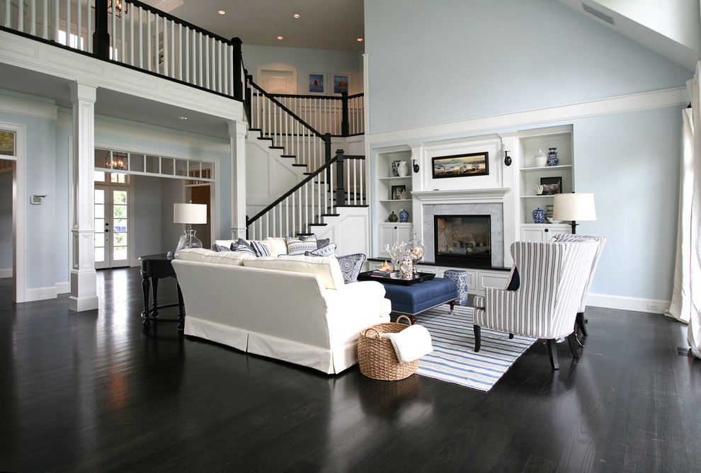 Example of an ornate black floor living room design in Portland with blue walls