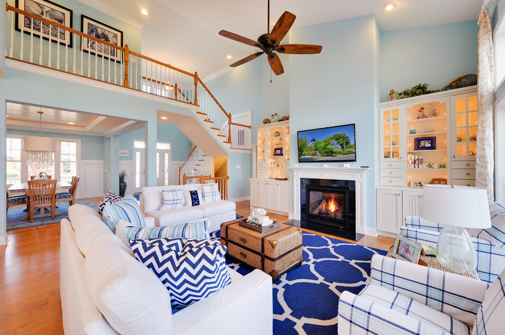 Beach style formal open plan living room in Philadelphia with a standard fireplace, a wall mounted tv and feature lighting.