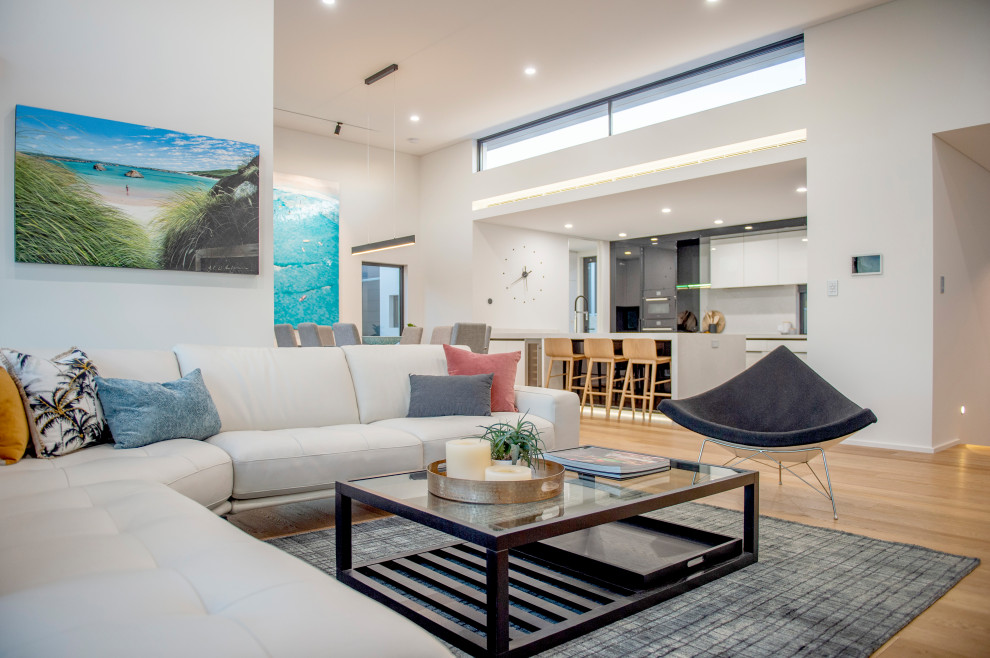Photo of a medium sized contemporary open plan living room in Perth with white walls, light hardwood flooring, a ribbon fireplace, a stone fireplace surround, a built-in media unit and brown floors.