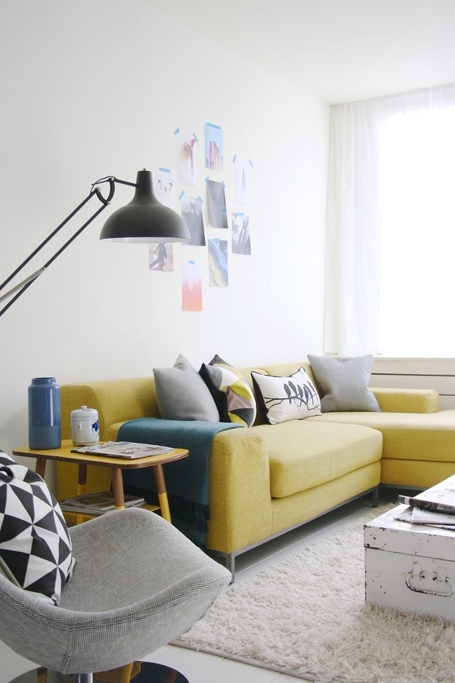 Inspiration for a medium sized scandi grey and yellow living room in Amsterdam with white walls and feature lighting.