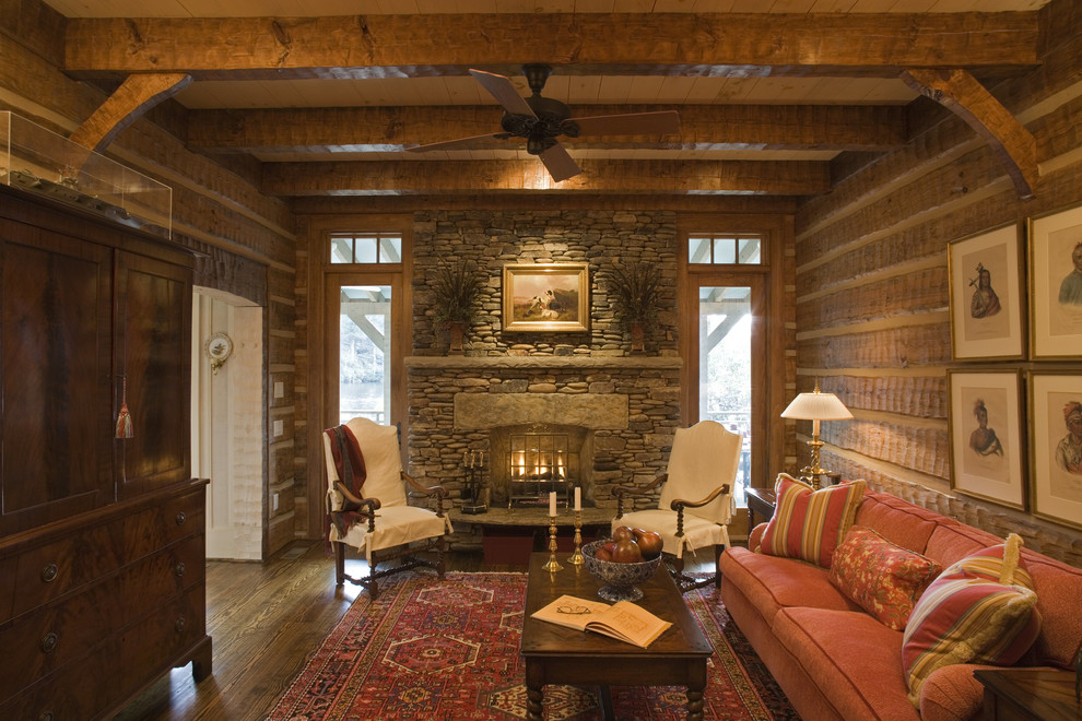 Inspiration for a mid-sized rustic enclosed and formal living room remodel in Other with brown walls, a standard fireplace, a stone fireplace and no tv