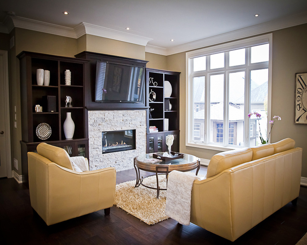 Living room - mid-sized transitional open concept dark wood floor living room idea in Toronto with beige walls, a standard fireplace, a tile fireplace and a wall-mounted tv