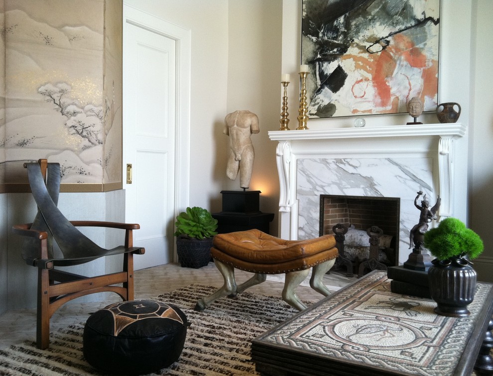 This is an example of an eclectic living room in San Francisco with beige walls and a standard fireplace.