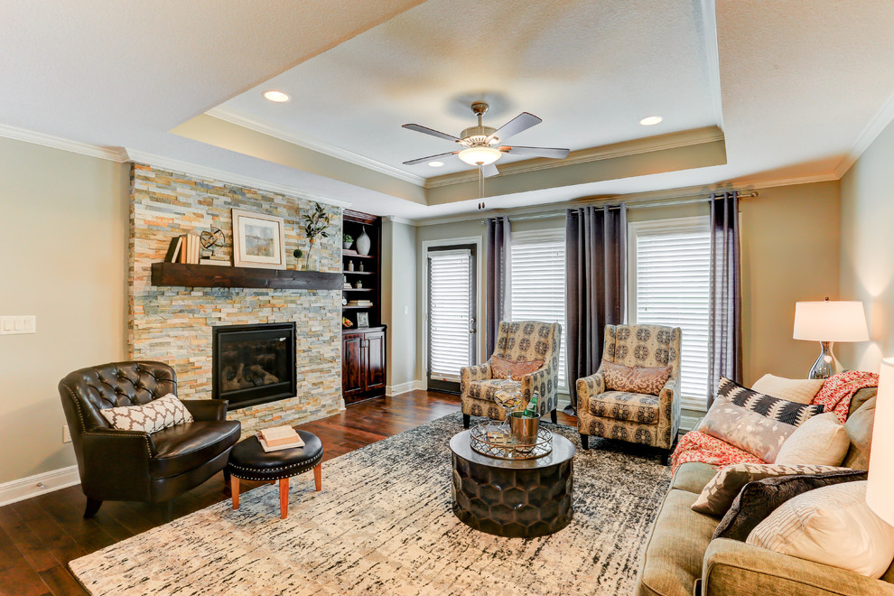 Medium sized classic formal enclosed living room in Kansas City with beige walls, medium hardwood flooring, a standard fireplace and a stone fireplace surround.
