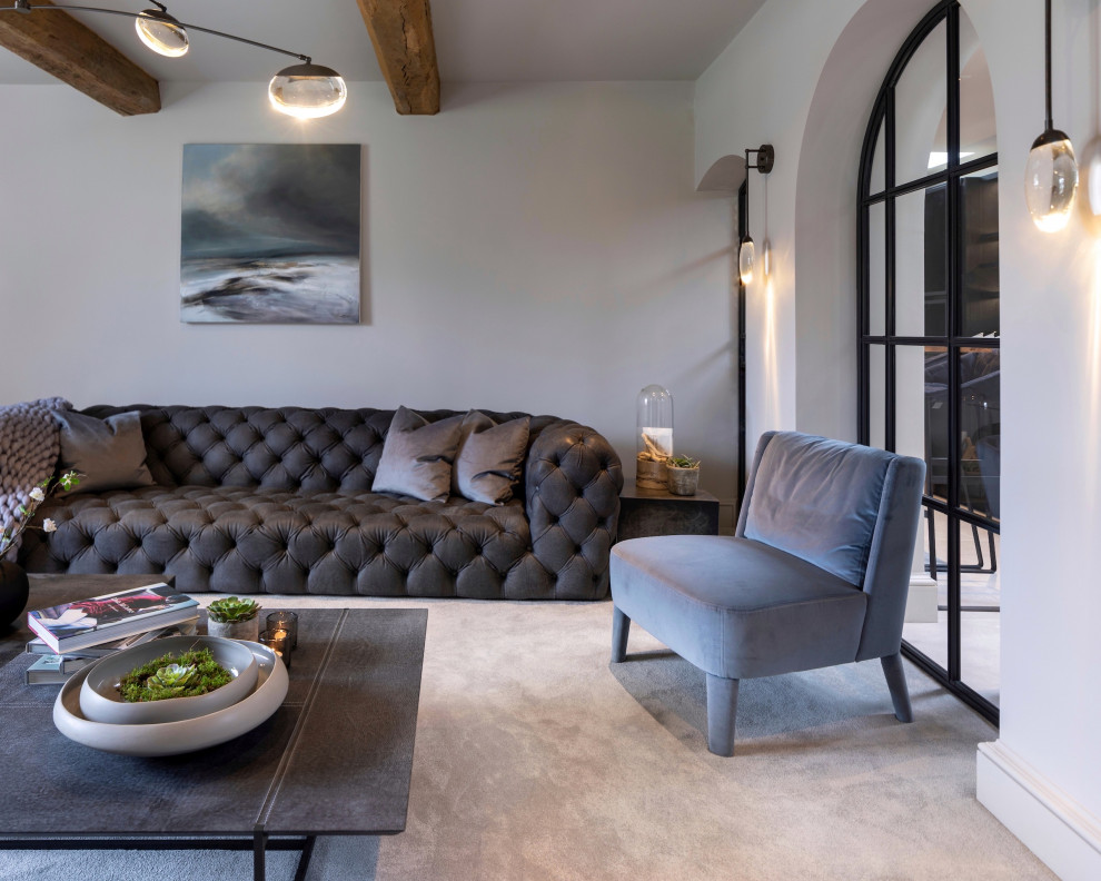 Large contemporary formal enclosed living room in Cheshire with carpet, a wood burning stove, a plastered fireplace surround, a wall mounted tv and grey floors.