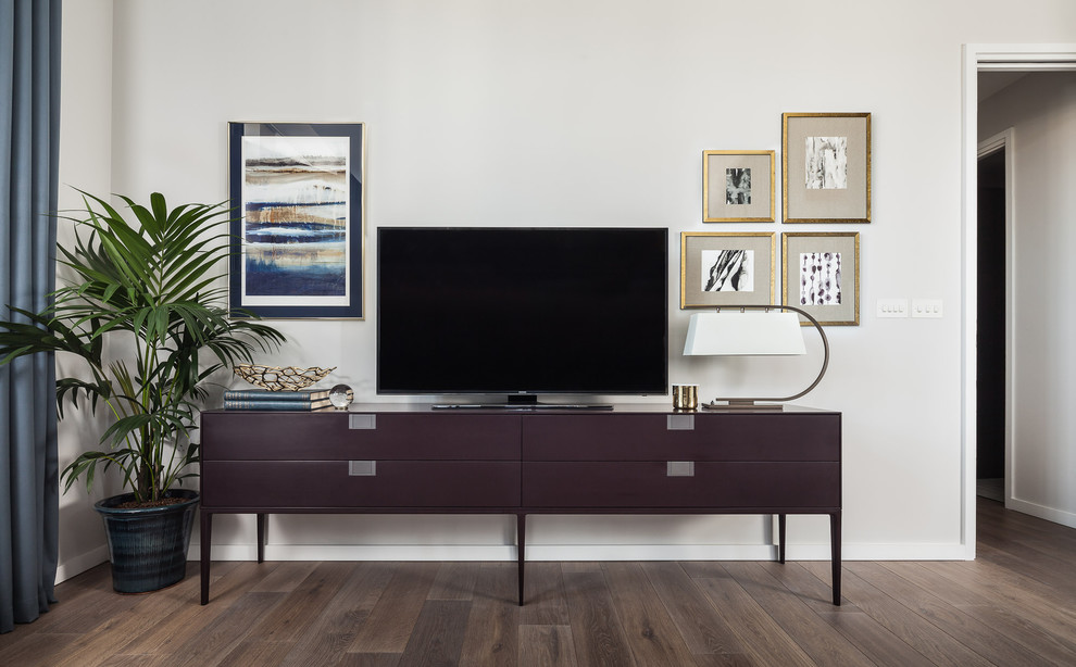 Example of a mid-sized trendy formal and open concept light wood floor living room design in London with white walls and a tv stand
