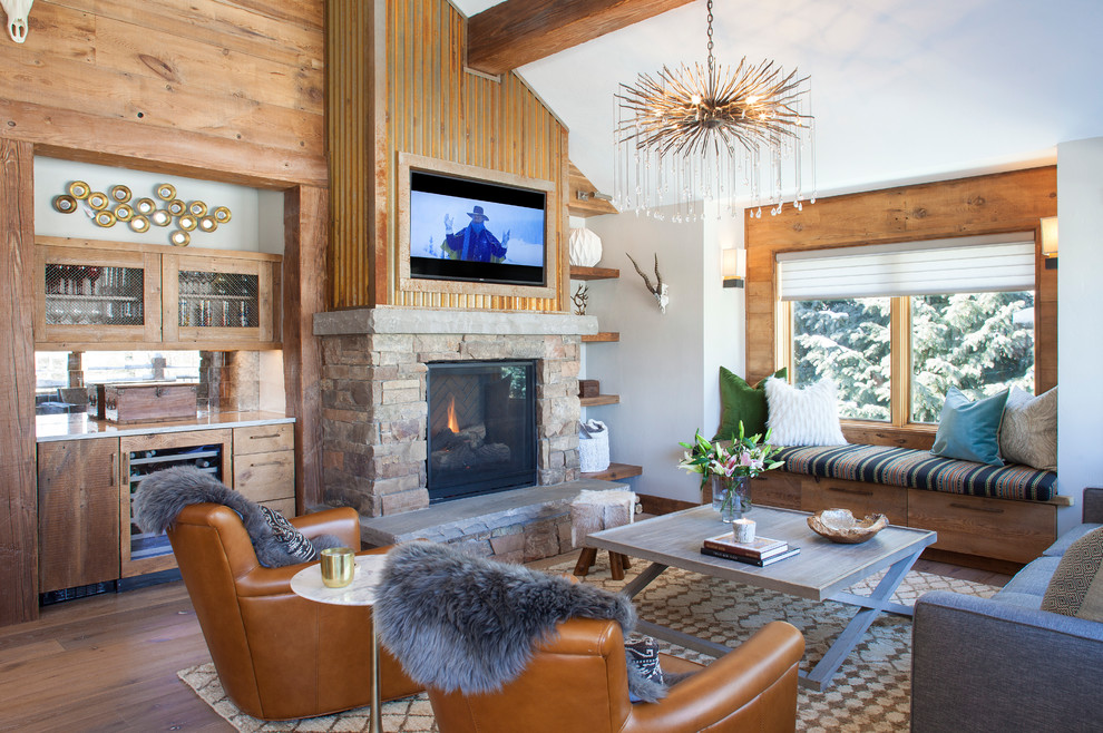 Inspiration for a mid-sized rustic open concept brown floor and medium tone wood floor living room remodel in Other with a bar, a standard fireplace, a wall-mounted tv, white walls and a brick fireplace