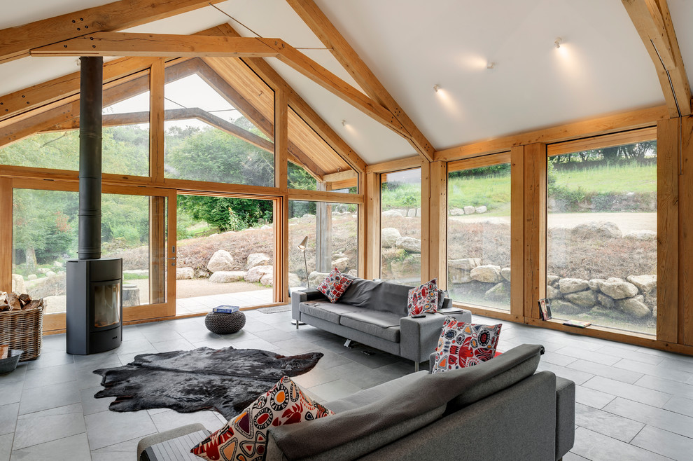 Rustic formal open plan living room in Devon with slate flooring.