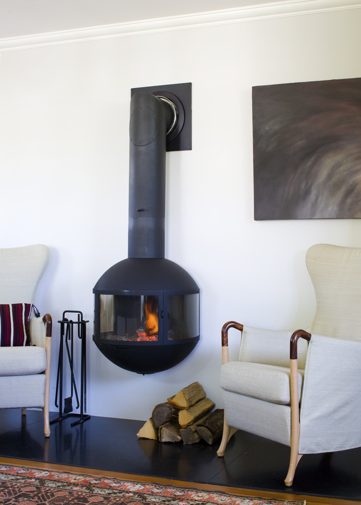 Beach style living room photo in Boston with a wood stove