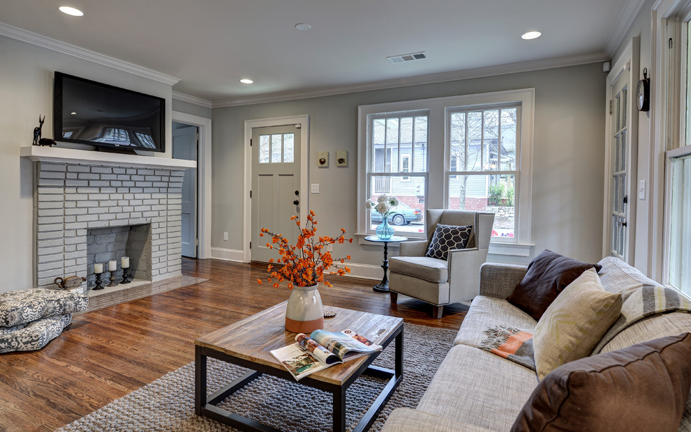 Design ideas for a small traditional open plan living room in Atlanta with grey walls, medium hardwood flooring, a standard fireplace and a brick fireplace surround.