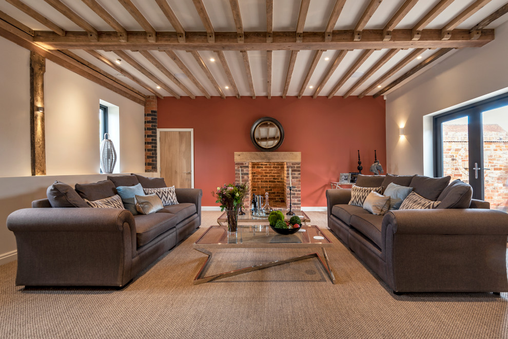 Esempio di un grande soggiorno minimalista con pareti rosa, moquette, camino classico, cornice del camino in mattoni e pavimento beige