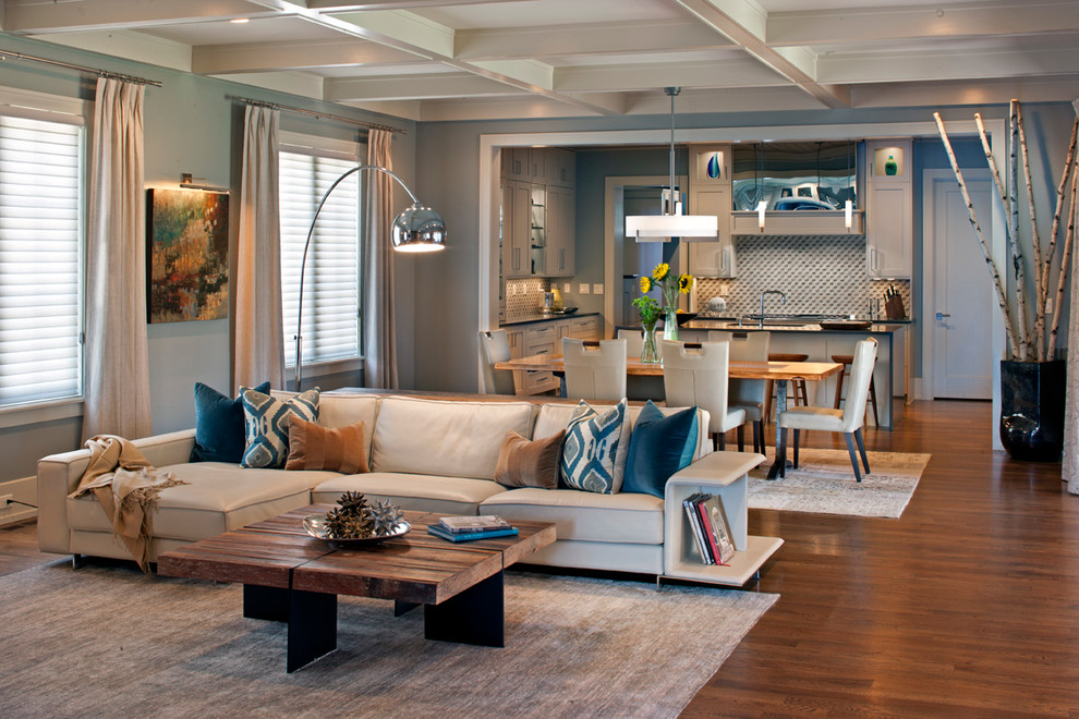Example of a large transitional open concept medium tone wood floor living room design in Other with gray walls