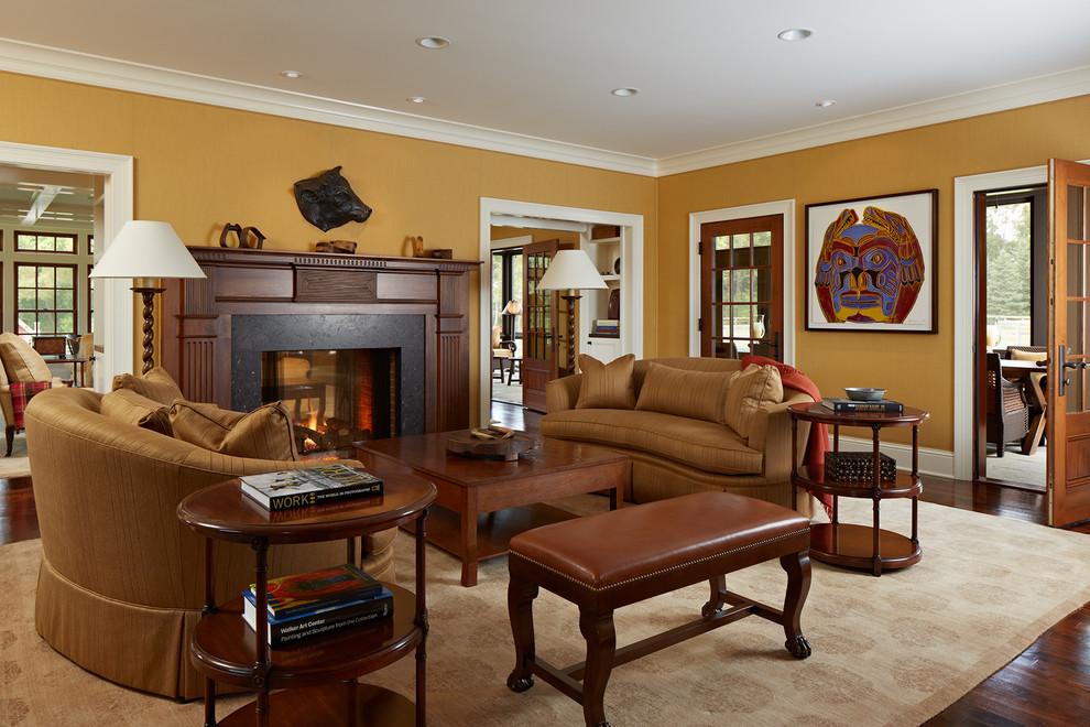 Example of a large mountain style formal and enclosed dark wood floor living room design in Minneapolis with yellow walls, a two-sided fireplace and a wood fireplace surround