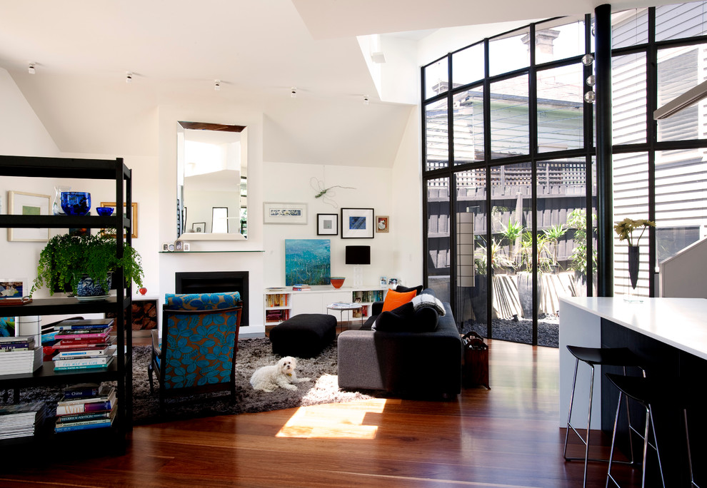 Design ideas for a contemporary open plan living room in Melbourne with white walls and a standard fireplace.