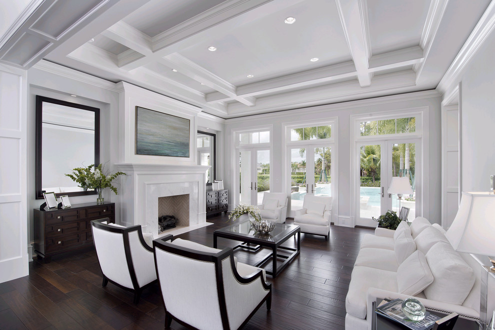 This is an example of a traditional living room in Miami with white walls and feature lighting.