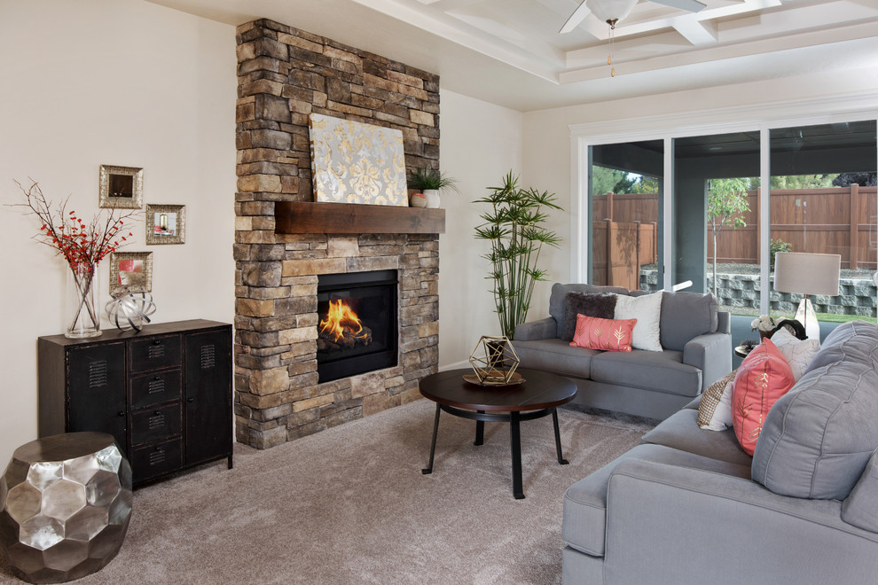 Inspiration for a medium sized traditional open plan living room in Boise with beige walls, carpet, a standard fireplace, a stone fireplace surround and a wall mounted tv.