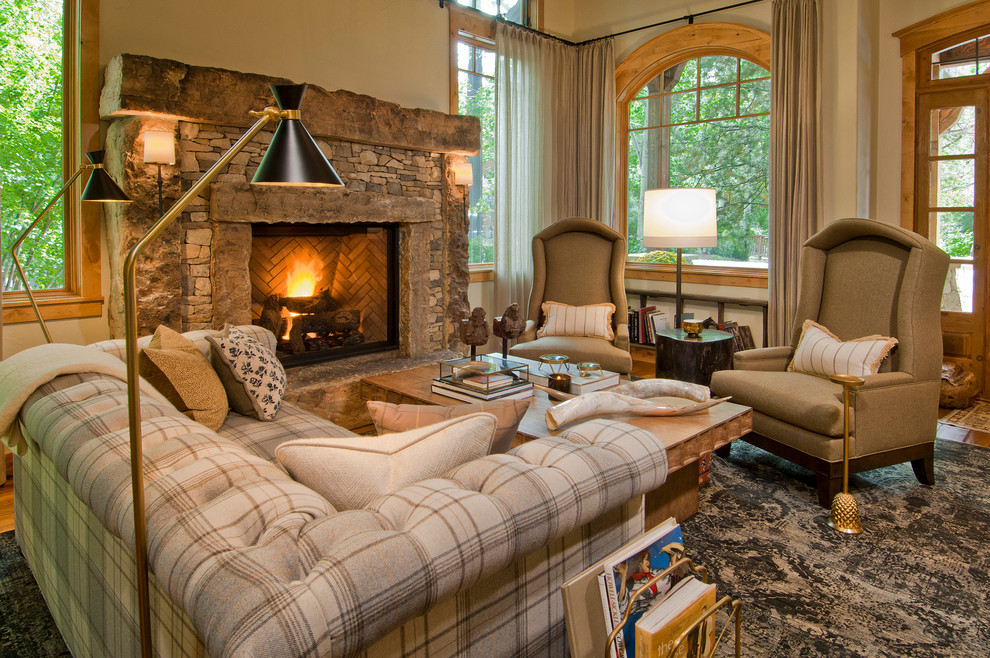 Aménagement d'un salon montagne de taille moyenne et ouvert avec un sol en bois brun et un manteau de cheminée en pierre.