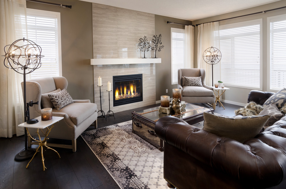 Trendy black floor living room photo in Calgary with a tile fireplace