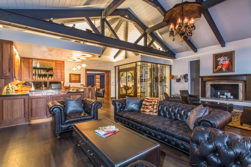 This is an example of a traditional open plan living room in San Diego with white walls, dark hardwood flooring, a standard fireplace and brown floors.