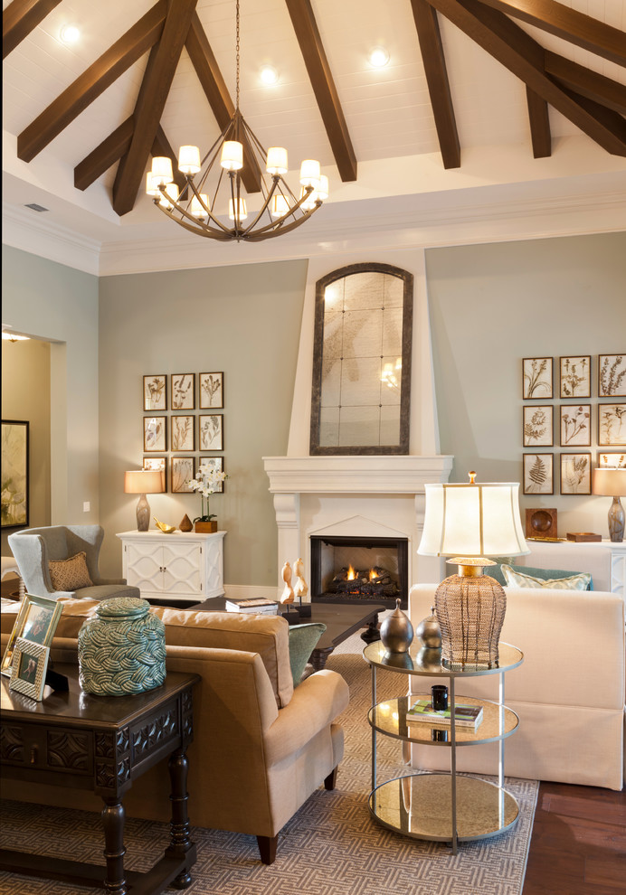 Idée de décoration pour un très grand salon design ouvert avec une salle de réception, un mur bleu, parquet foncé, une cheminée standard, un manteau de cheminée en pierre et un sol marron.