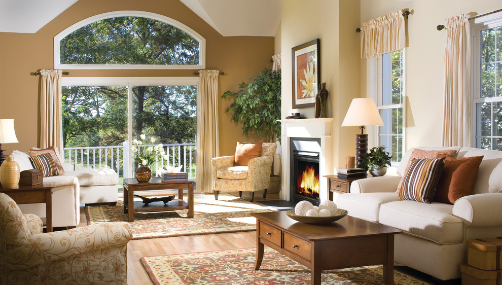 Inspiration for a traditional living room curtain in Boston with beige walls and a standard fireplace.