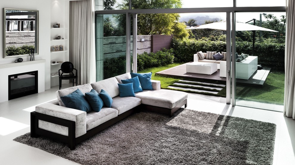 Living room - contemporary open concept living room idea in Hong Kong with white walls and a standard fireplace