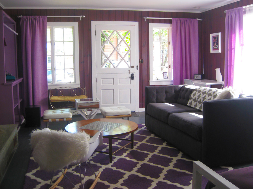 Réalisation d'un salon bohème de taille moyenne et ouvert avec un mur violet, une cheminée standard, un manteau de cheminée en carrelage et un téléviseur dissimulé.
