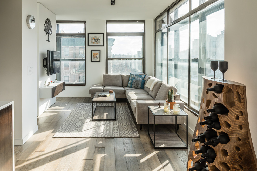 Living room - mid-sized contemporary dark wood floor and brown floor living room idea in New York with white walls and a wall-mounted tv