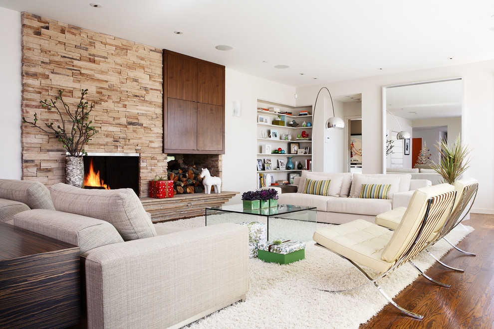 Retro formal enclosed living room in San Francisco with white walls, a standard fireplace, a stone fireplace surround and no tv.