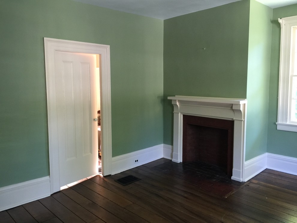 Medium sized classic formal enclosed living room in Cleveland with green walls, dark hardwood flooring, a standard fireplace and a plastered fireplace surround.