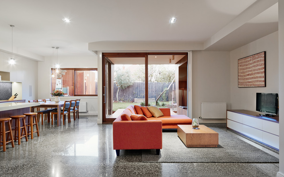 Photo of a large contemporary open plan living room in Melbourne with white walls, concrete flooring and grey floors.