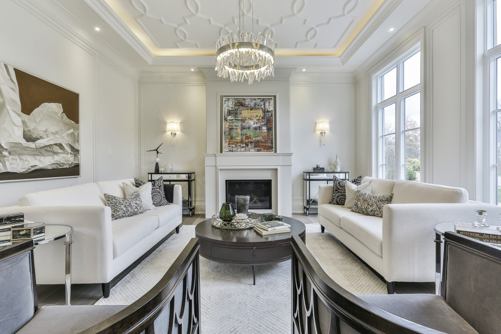 Traditional formal enclosed living room in Toronto with white walls, medium hardwood flooring, a standard fireplace, no tv, brown floors, a drop ceiling and panelled walls.