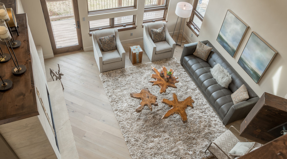 Large contemporary enclosed living room in Denver with beige walls, light hardwood flooring, a built-in media unit, beige floors and a ribbon fireplace.