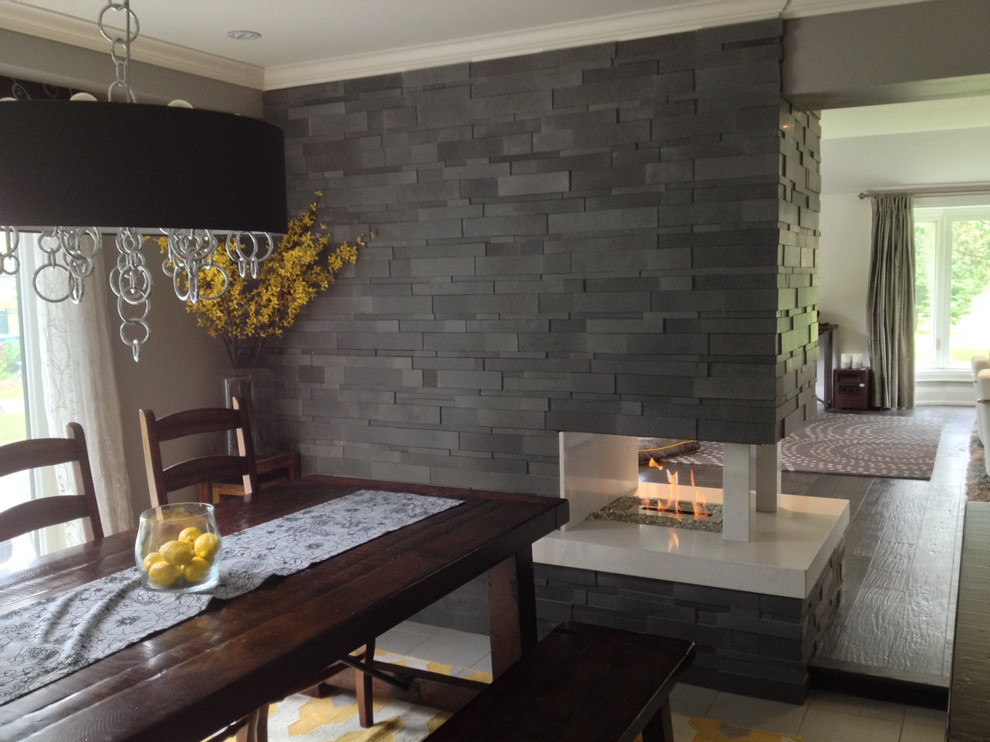 Идея дизайна: открытая гостиная комната среднего размера в стиле модернизм с серыми стенами, двусторонним камином и фасадом камина из камня без телевизора