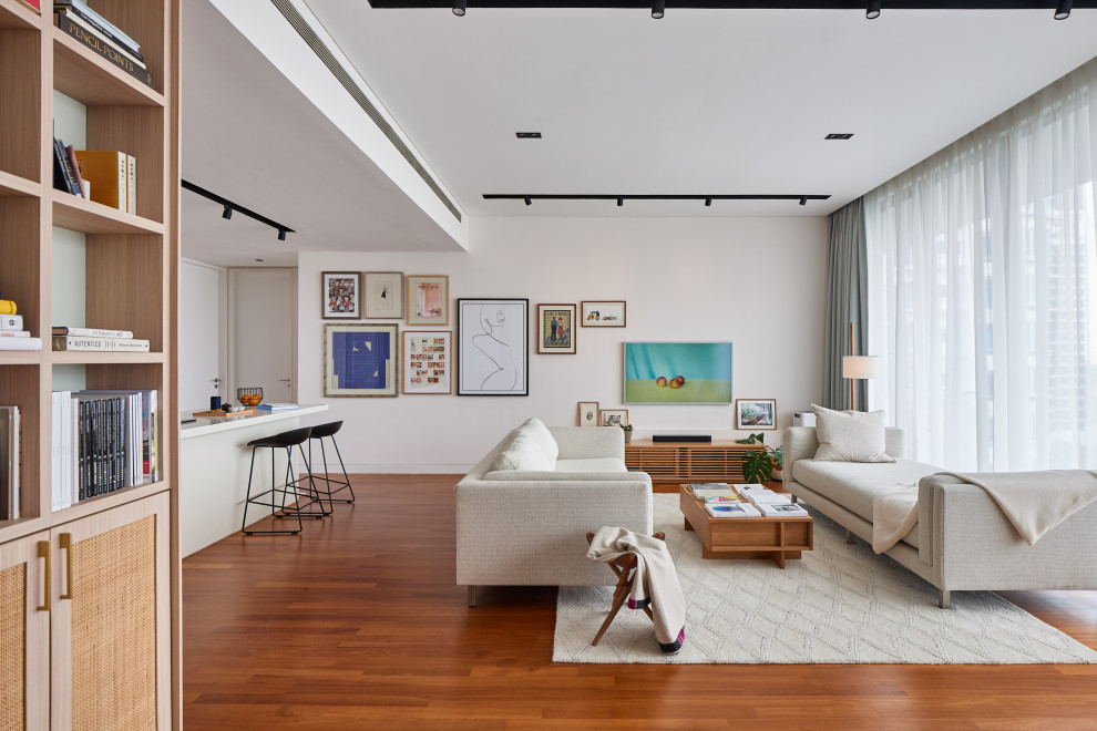 Example of a trendy open concept medium tone wood floor and brown floor living room design in Singapore with white walls