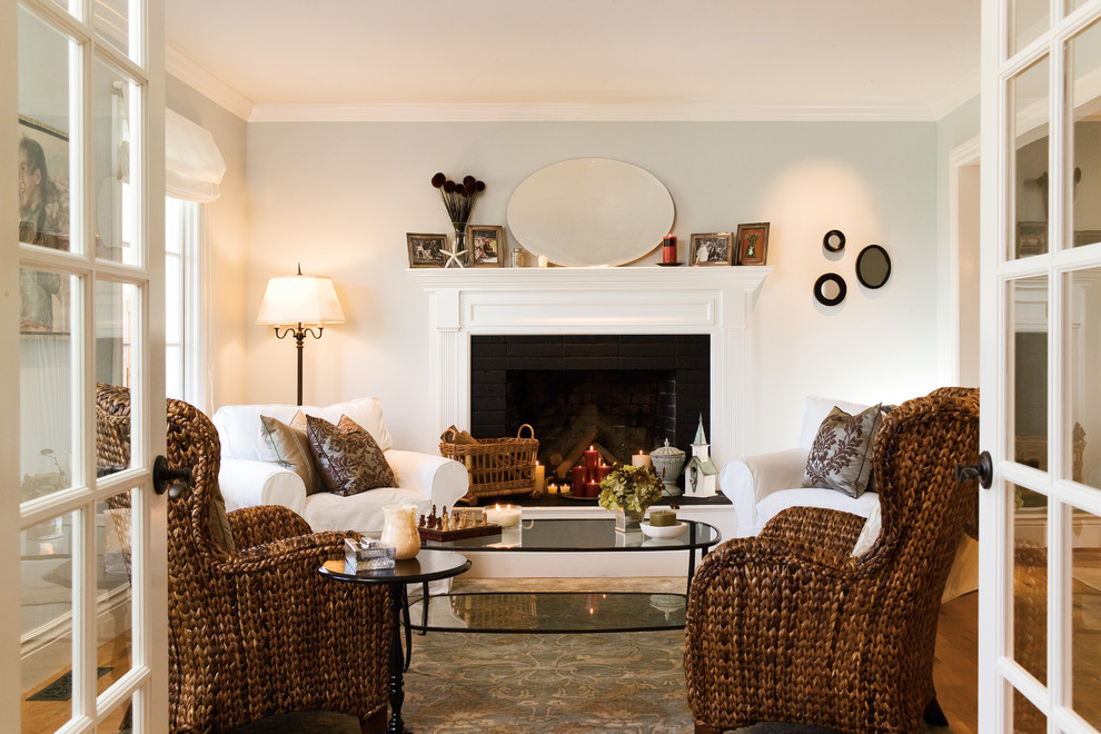 Inspiration for a small coastal open concept and formal medium tone wood floor living room remodel in San Francisco with blue walls, a standard fireplace, a brick fireplace and no tv