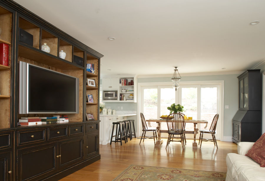 Photo of a medium sized contemporary formal open plan living room in San Francisco with blue walls, medium hardwood flooring, a built-in media unit, a standard fireplace and a brick fireplace surround.