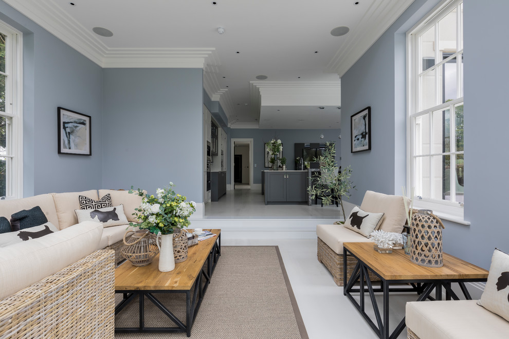 Inspiration for a large contemporary open concept white floor living room remodel in London with blue walls