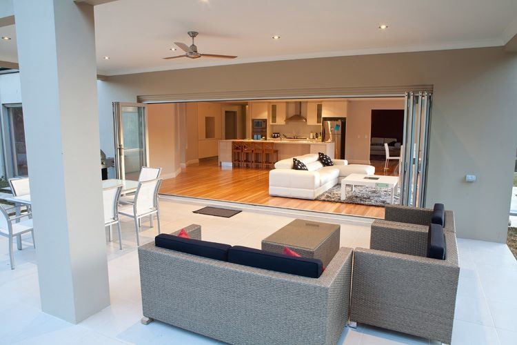 This is an example of a contemporary open plan living room in Sydney with light hardwood flooring.