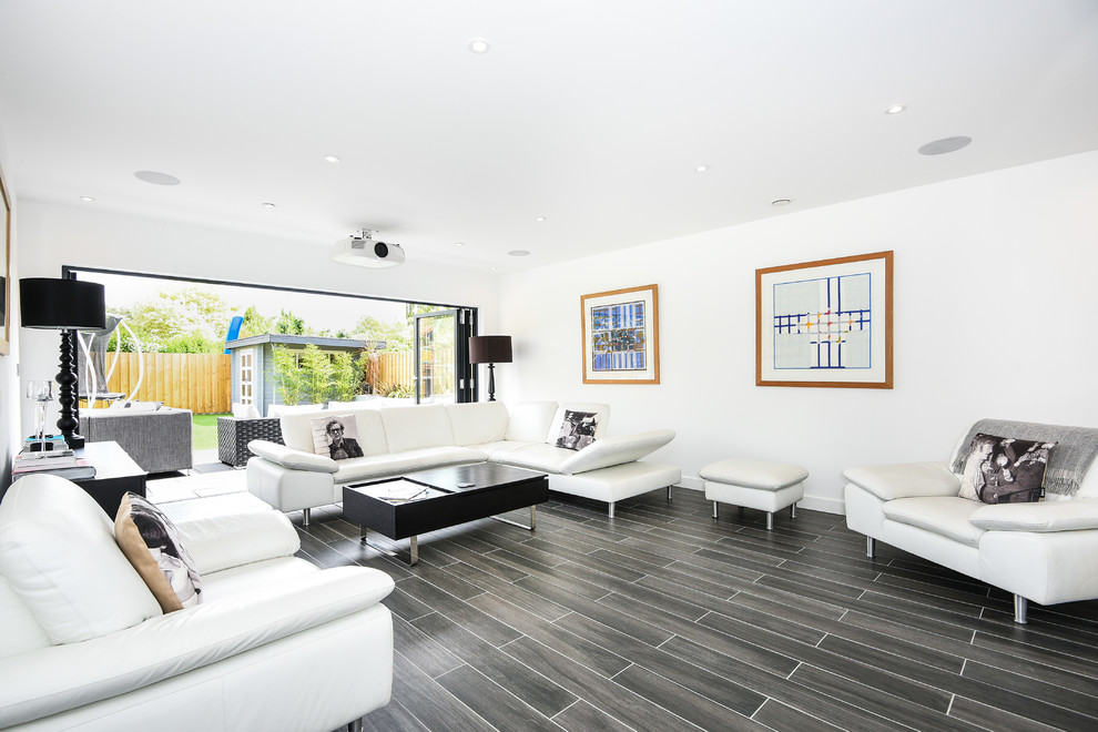 Medium sized contemporary open plan living room in Buckinghamshire with white walls, ceramic flooring, no fireplace, grey floors and a wall mounted tv.