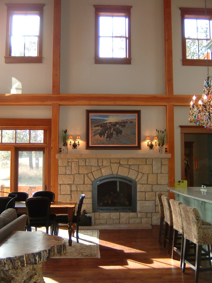Example of a large mountain style open concept dark wood floor and brown floor living room design in Other with white walls, a standard fireplace, a stone fireplace and no tv