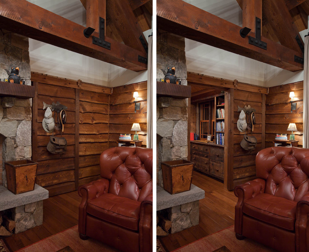 This is an example of a rustic mezzanine living room in Boston with a reading nook, medium hardwood flooring, a standard fireplace, a stone fireplace surround and no tv.