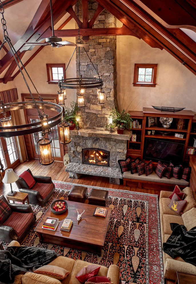 Design ideas for a large rustic open plan living room in Bridgeport with beige walls, medium hardwood flooring, a standard fireplace, a stone fireplace surround, brown floors and a built-in media unit.
