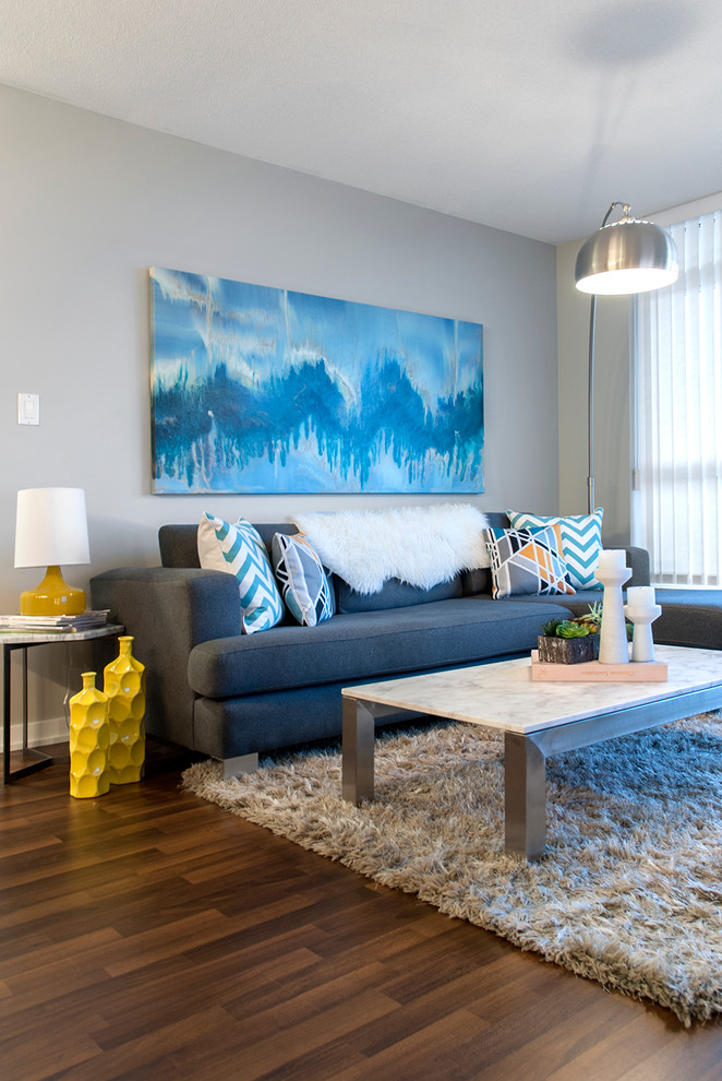 Example of a trendy open concept dark wood floor living room design in Vancouver with gray walls