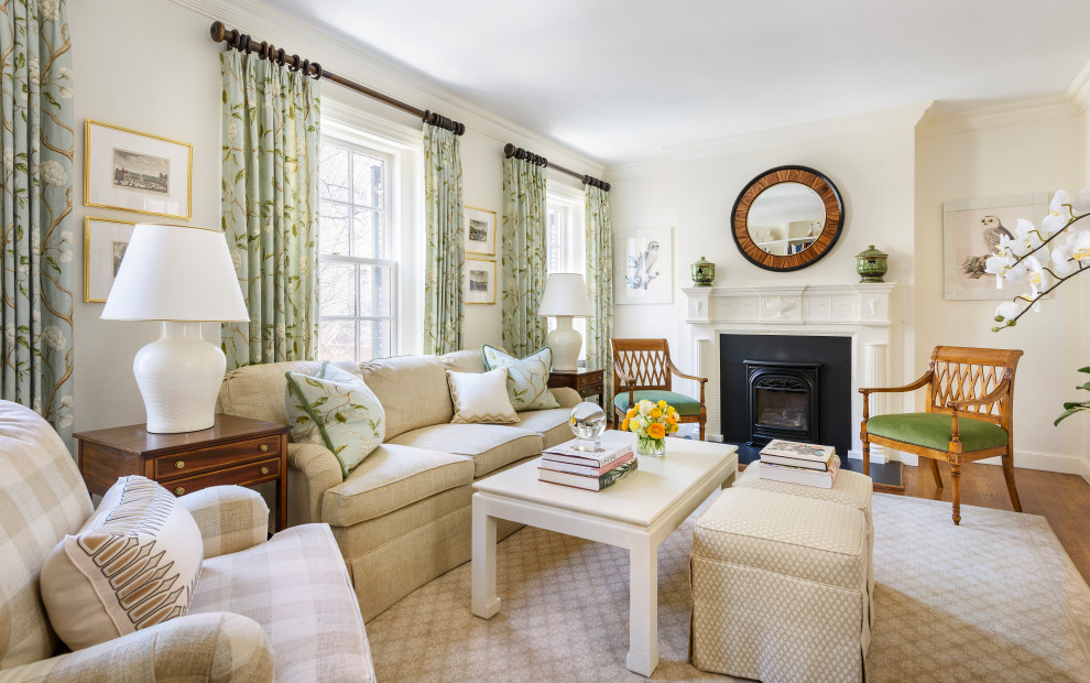 Traditional living room in Boston with white walls, medium hardwood flooring, a standard fireplace and brown floors.