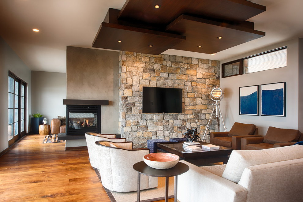 Medium sized contemporary formal open plan living room in Minneapolis with beige walls, medium hardwood flooring, a corner fireplace, a metal fireplace surround, a wall mounted tv and brown floors.