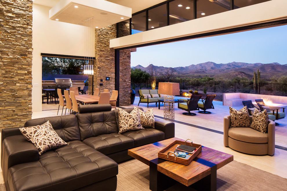 Contemporary open plan living room in Phoenix with beige floors.