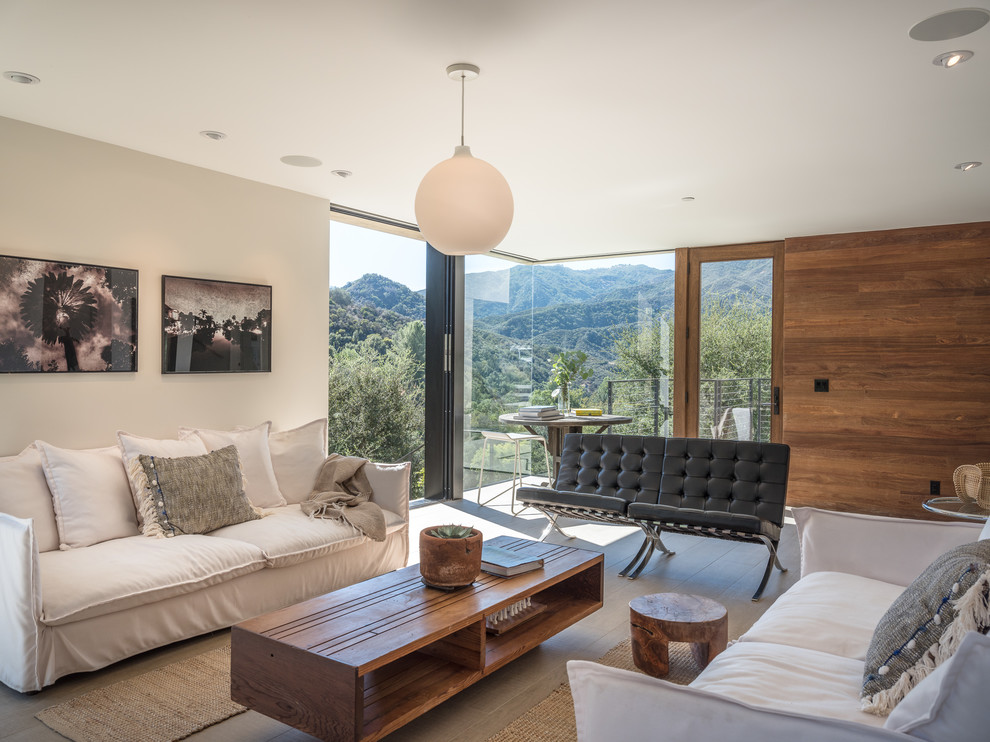 Photo of a medium sized contemporary open plan living room in Los Angeles with brown walls and no fireplace.